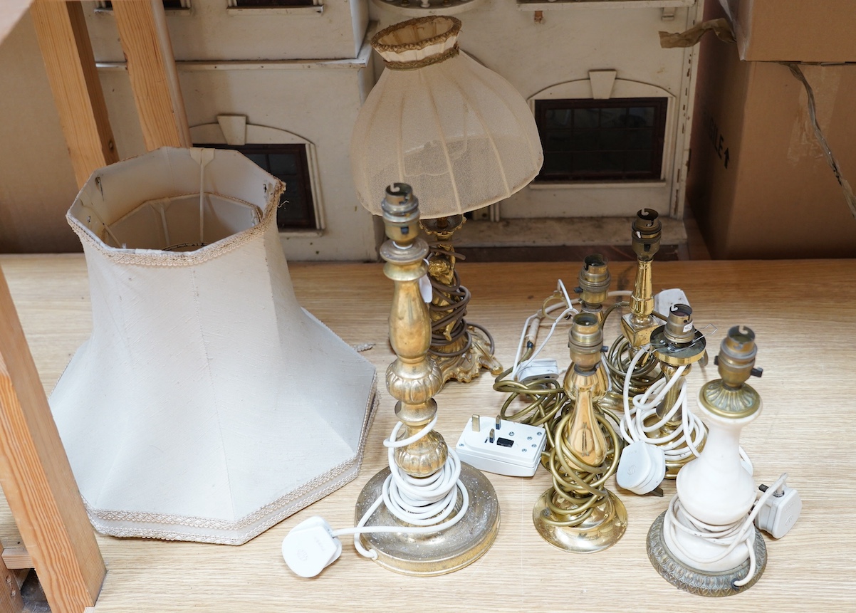 A figurative gilt metal table lamp, five brass table lamps and an alabaster lamp, tallest 35cm high. Condition - one poor, the others fair to good